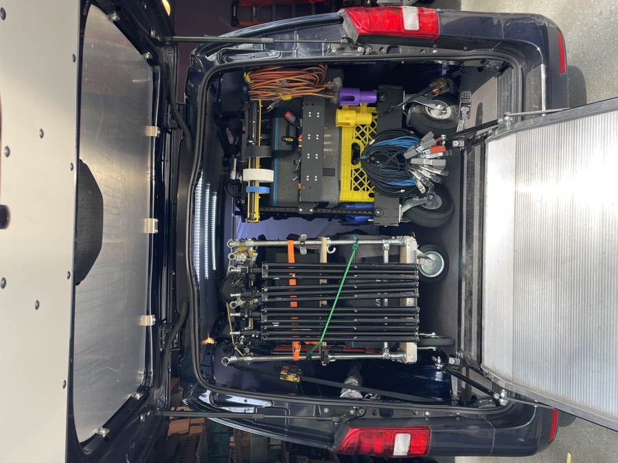 Production van with the camera cart and G&E cart loaded, ramp down
